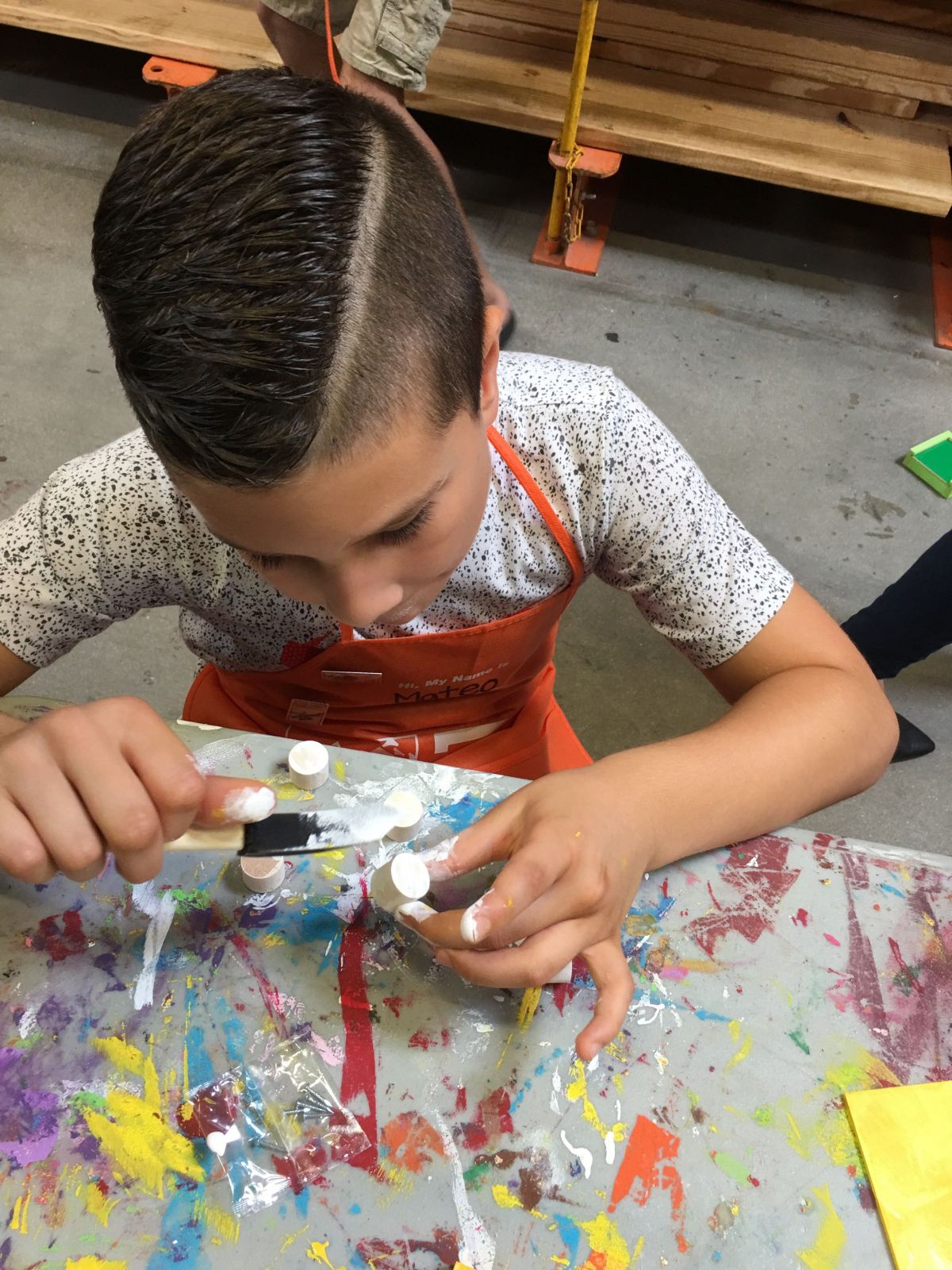 Photo of a young boy at school doing arts and crafts, focused